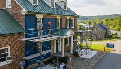 Professional painters in Lancaster, PA applying interior painting services for a local home